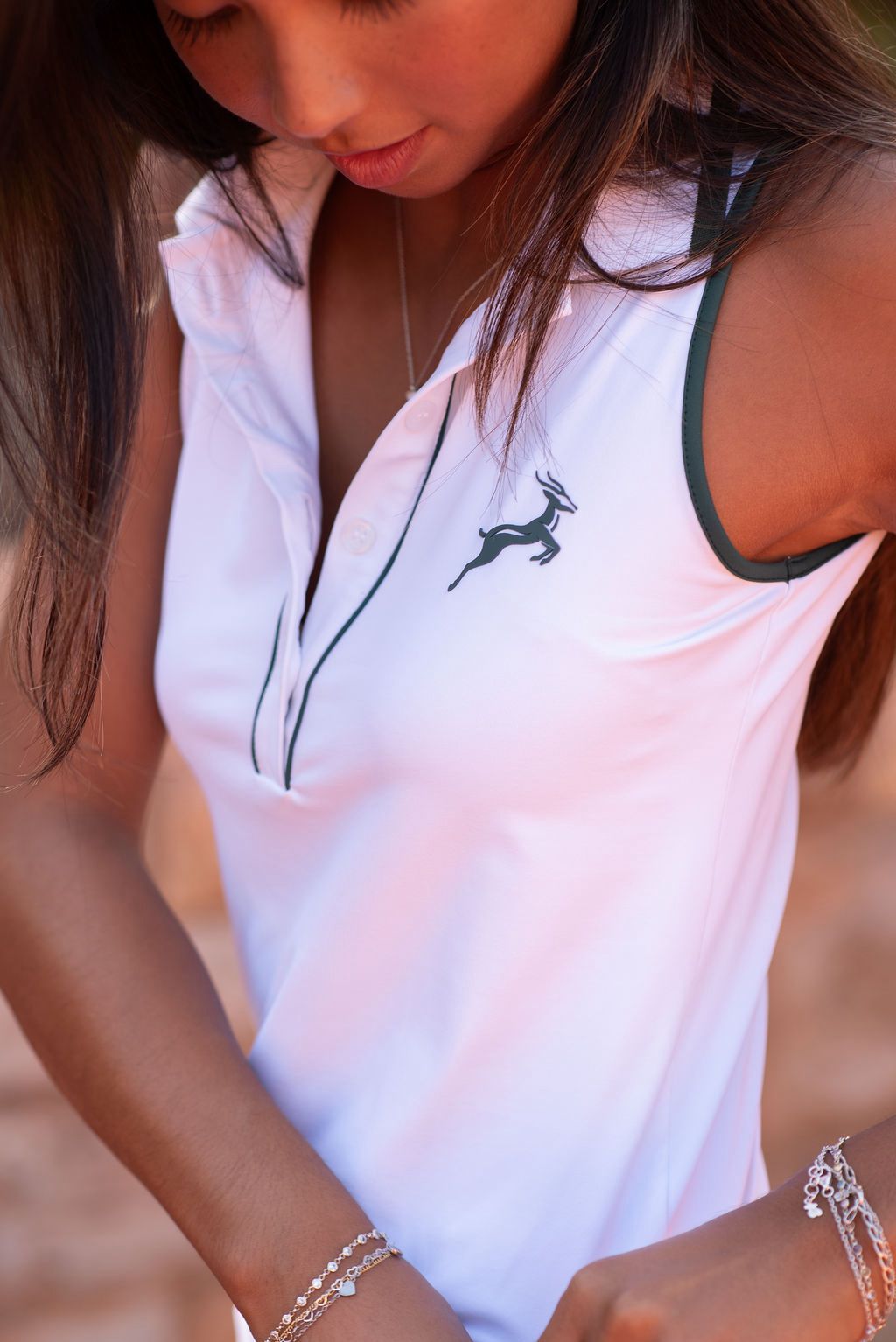 White sleeveless tennis polo with green detailing, Nordi Activewear
